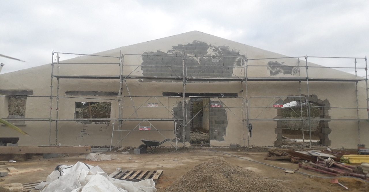 Reconstruction de la façade, création d'une ouverture porte-fenêtre en remplacement de la porte de la grange. Enduisage.